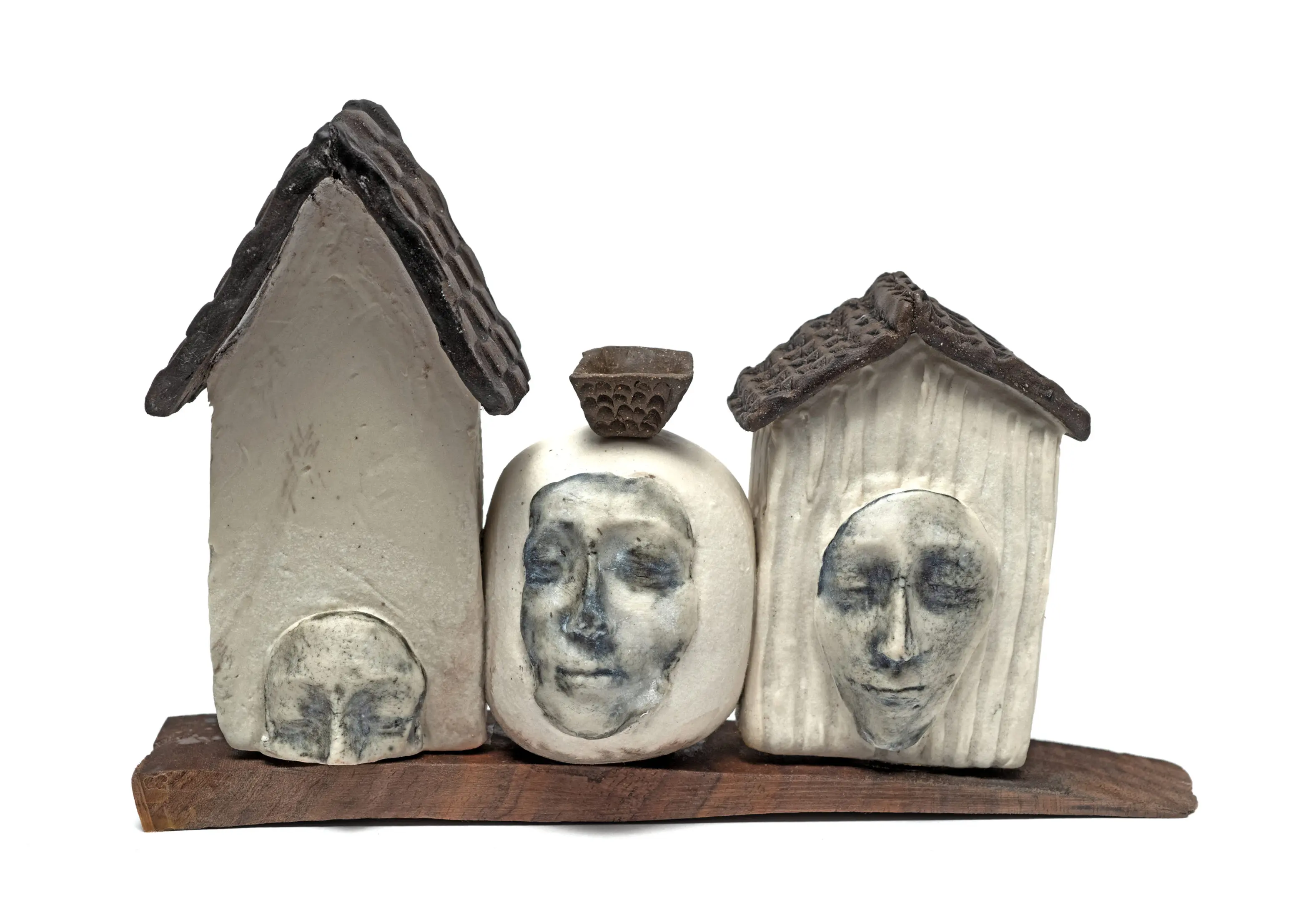 Mixed media sculpture of simplified houses with abstracted female figures